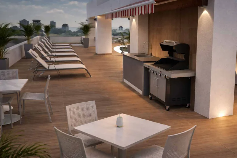 Terraza con BBQ y área de camastros en el nivel social de PH Omar Park View